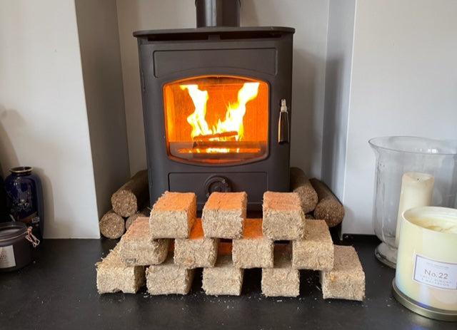  High Energy Super dry Wood Fuel Briquettes twin pack in front of wood stove